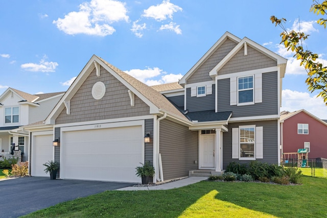 view of front of property featuring a garage and a front yard