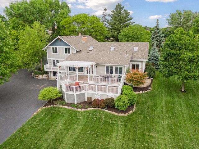 3685 Watertown Rd, Orono, MN 55359 - rear view of house with a pergola, roof with shingles, a lawn, asphalt driveway, and a deck