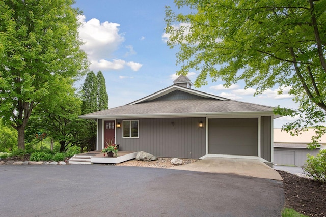 3685 Watertown Rd, Orono, MN 55359 - view of front facade with asphalt driveway, roof with shingles, and a garage