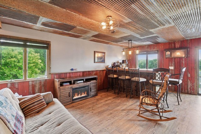 3685 Watertown Rd, Orono, MN 55359 - living room with wood walls, plenty of natural light, a bar, wood ceiling, and wood-type flooring