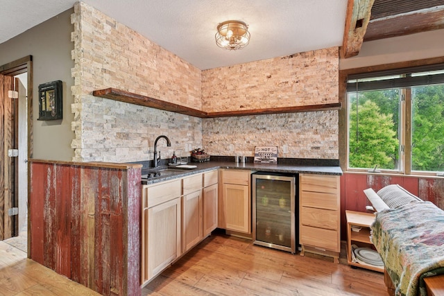 3685 Watertown Rd, Orono, MN 55359 - indoor wet bar featuring beverage cooler, light wood finished floors, and a textured ceiling