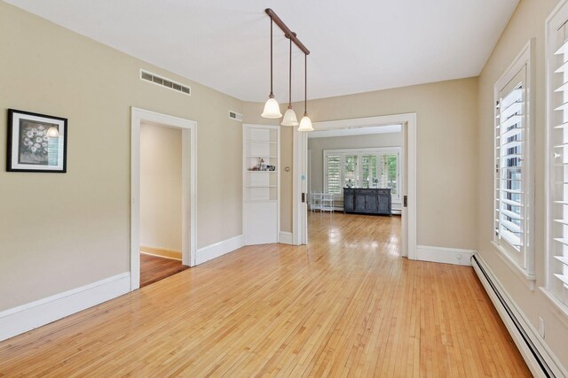 3685 Watertown Rd, Orono, MN 55359 - unfurnished room featuring a baseboard radiator, light wood-style flooring, and baseboards