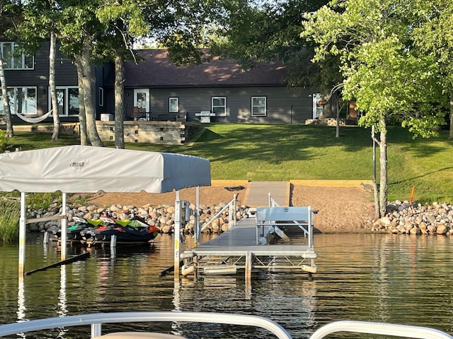 view of dock featuring a yard and a water view