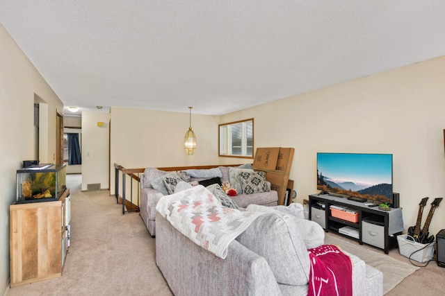 carpeted living room featuring a textured ceiling