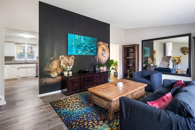 living room with sink and light hardwood / wood-style floors