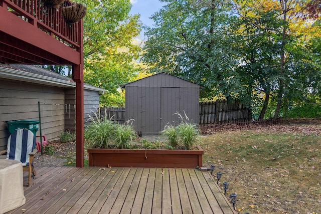 wooden deck with a shed and a lawn