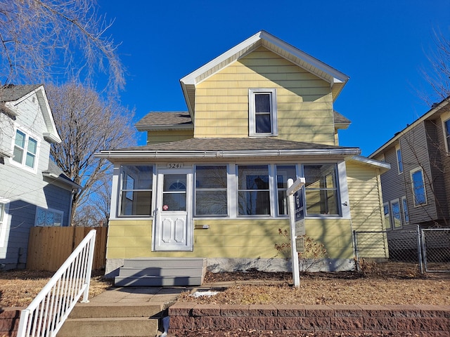 view of front of house featuring a sunroom