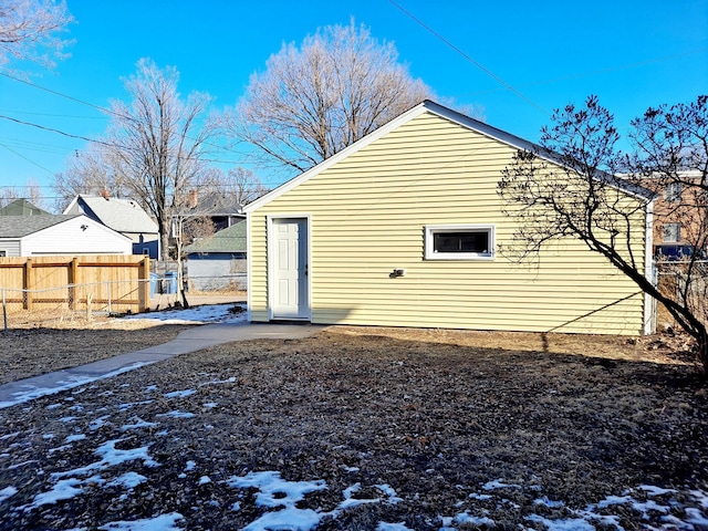 view of snow covered rear of property