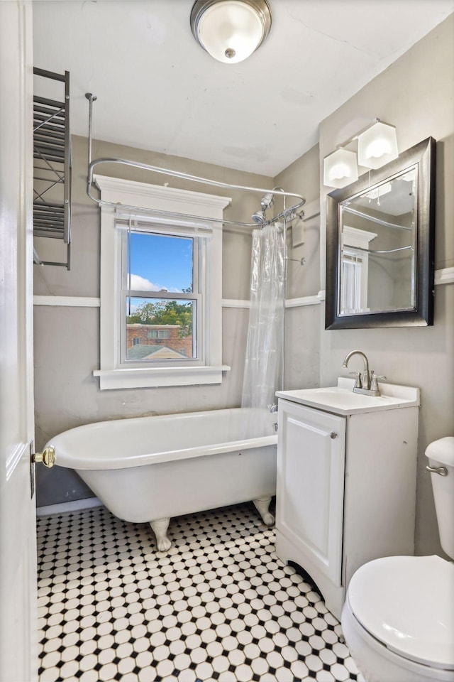 full bathroom with vanity, shower / bath combo, and toilet