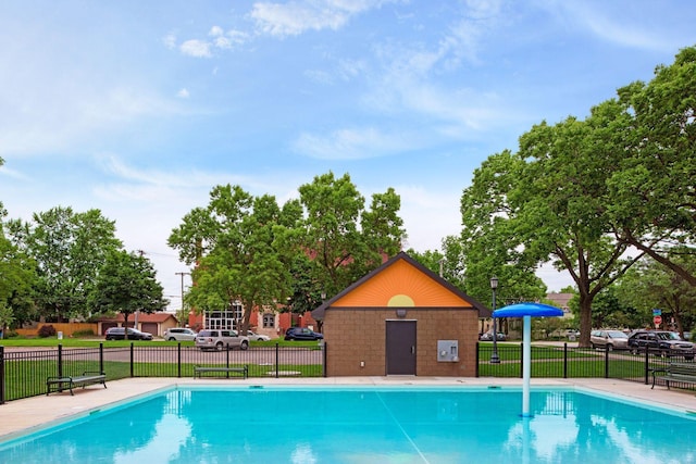 view of pool featuring a lawn