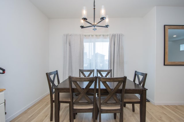 dining room featuring a notable chandelier and light wood-type flooring