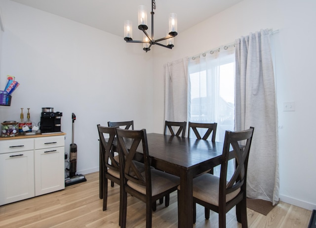 dining area featuring a chandelier and light wood-type flooring