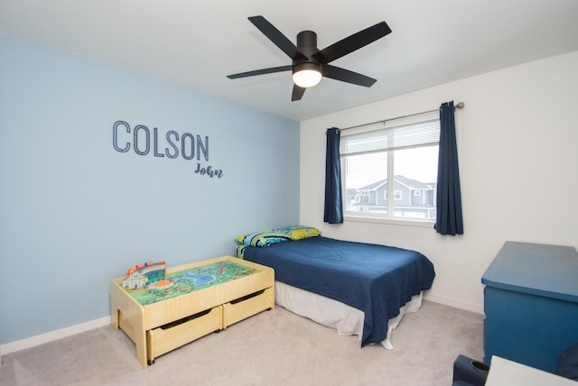 bedroom featuring ceiling fan and light carpet