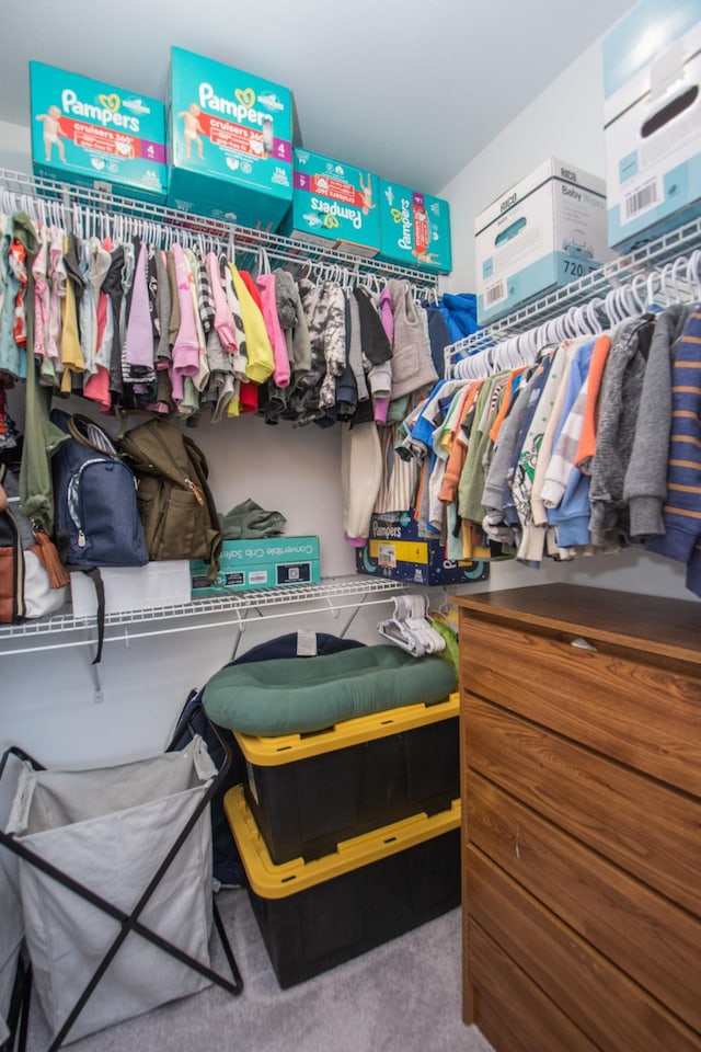 walk in closet with carpet