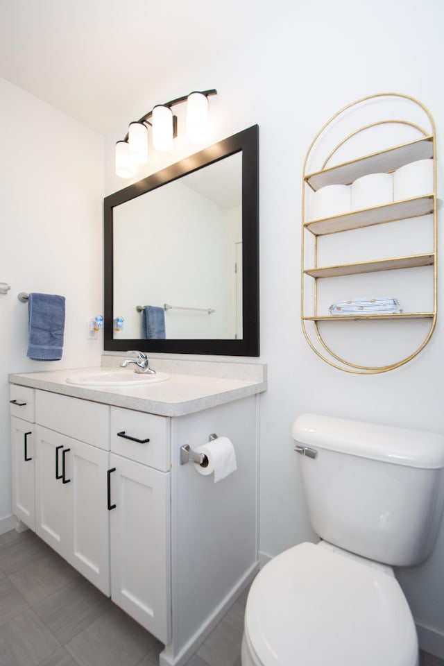 bathroom featuring vanity and toilet