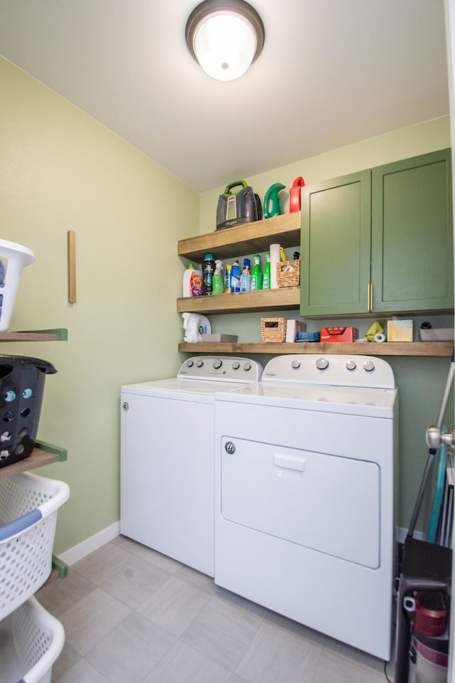 washroom featuring cabinets and separate washer and dryer