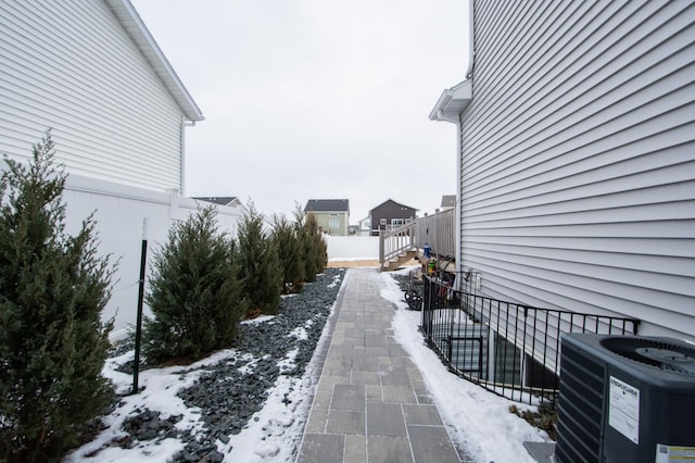 snow covered property featuring central air condition unit