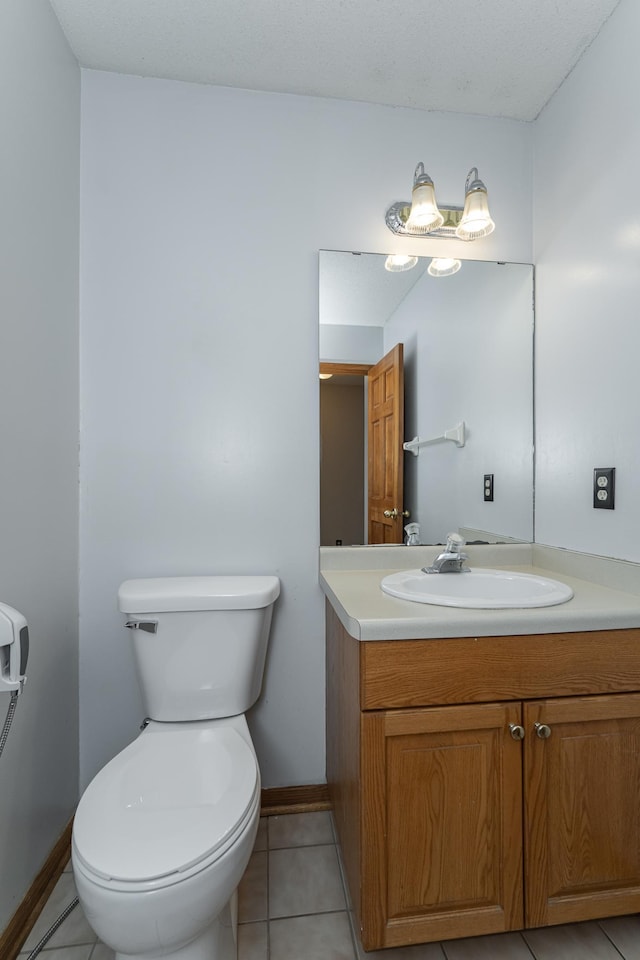 bathroom with tile patterned floors, vanity, and toilet