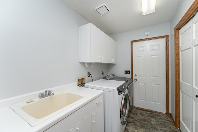 laundry room with cabinets, independent washer and dryer, and sink