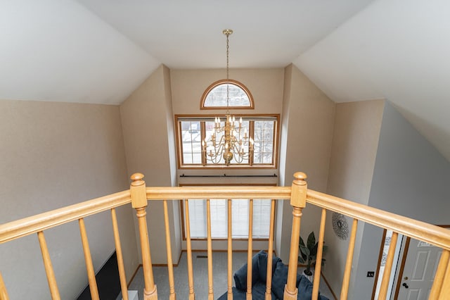 stairway featuring lofted ceiling, carpet flooring, and a notable chandelier