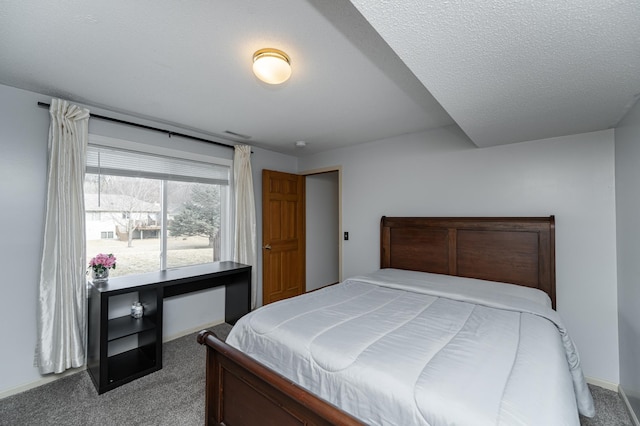 carpeted bedroom featuring a textured ceiling