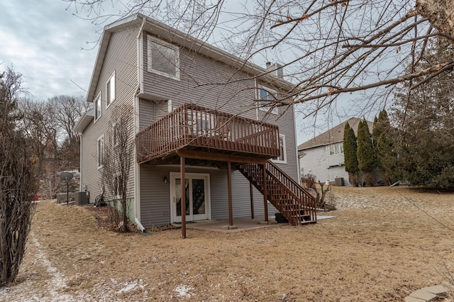 rear view of house featuring central AC unit and a deck