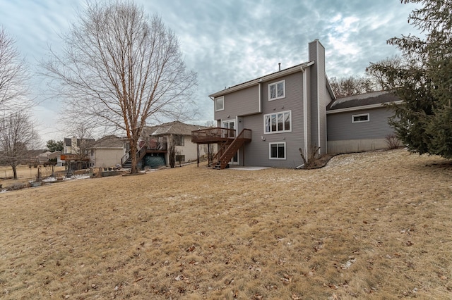 rear view of property featuring a yard and a deck