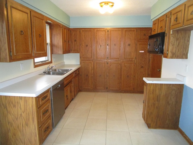 kitchen featuring light tile patterned floors, sink, and black appliances