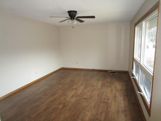 spare room featuring dark hardwood / wood-style flooring and ceiling fan