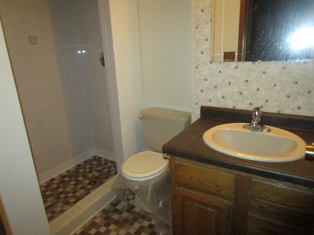 bathroom featuring vanity, tile patterned floors, a shower, and toilet