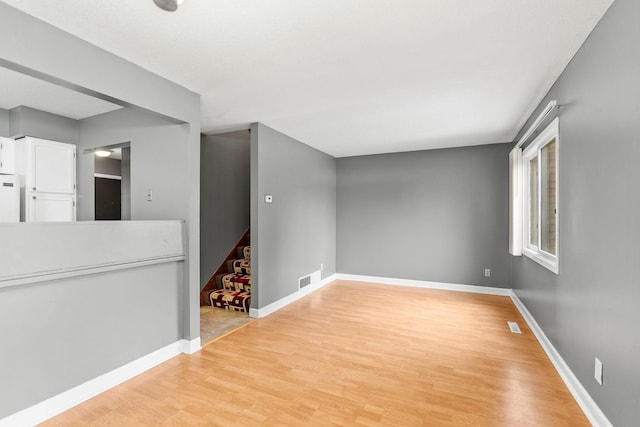 empty room with light hardwood / wood-style floors