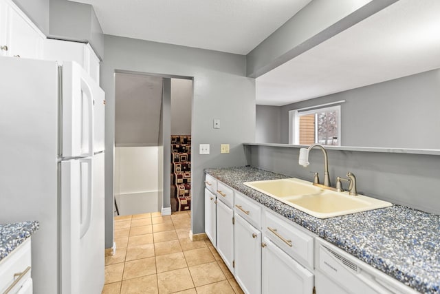 kitchen featuring white cabinetry, white appliances, sink, and light tile patterned floors