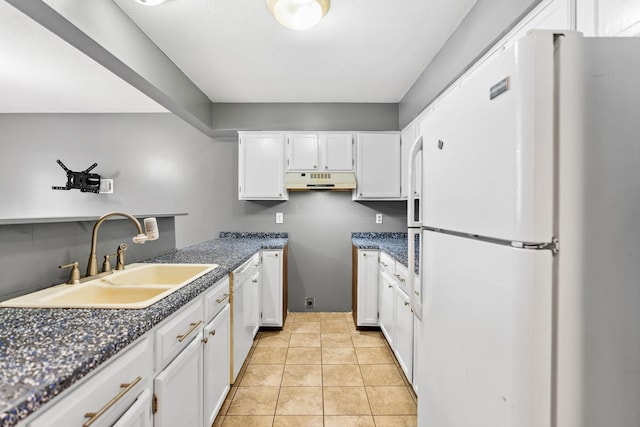 kitchen featuring white appliances, light tile patterned floors, sink, and white cabinets