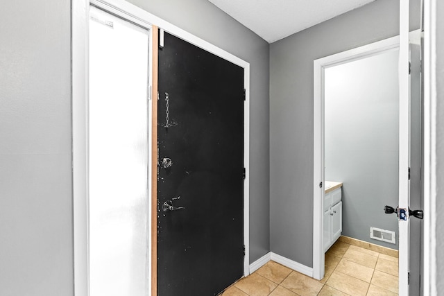 foyer featuring light tile patterned floors