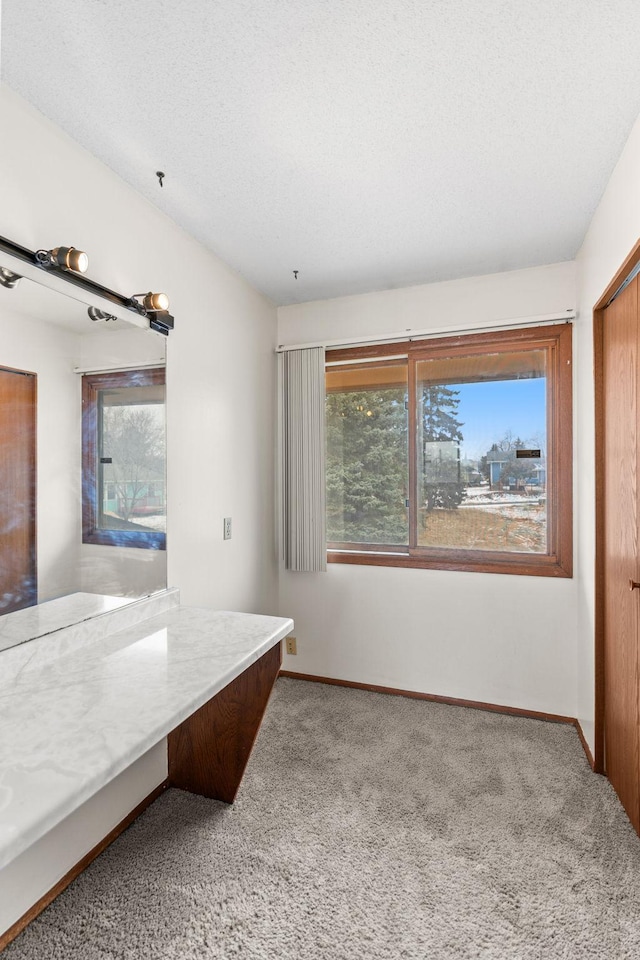 carpeted bedroom featuring a closet and a textured ceiling