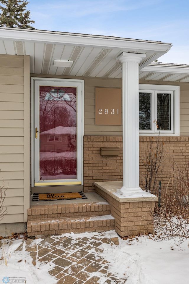 view of snow covered property entrance