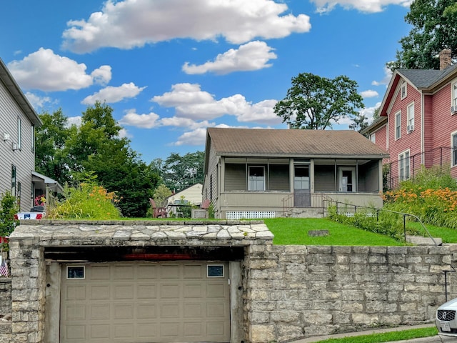 view of front of property featuring a garage and covered porch