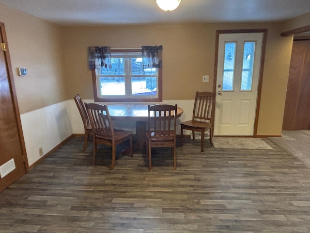 dining space with dark hardwood / wood-style flooring and a wealth of natural light