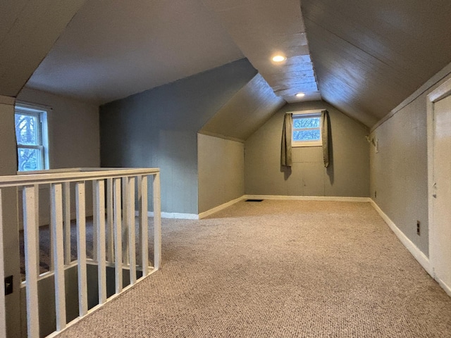 additional living space with lofted ceiling and carpet floors