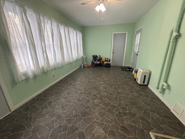 interior space with plenty of natural light and ceiling fan