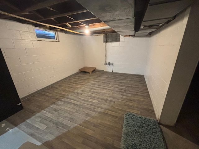 basement featuring dark hardwood / wood-style flooring