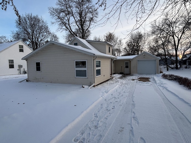 view of front of property featuring a garage and an outdoor structure