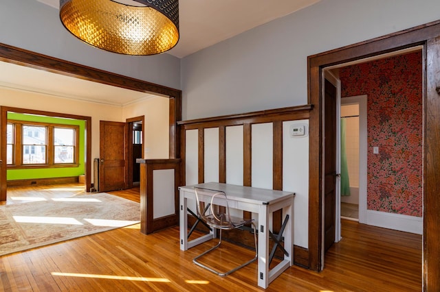 corridor featuring light wood-style floors and baseboards