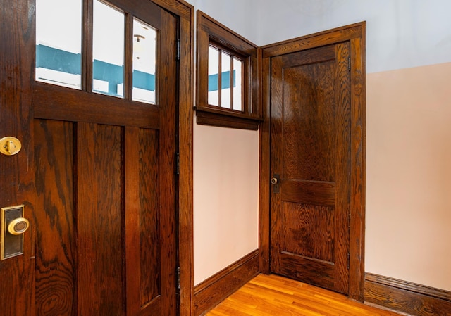 entryway with light wood-style flooring and baseboards