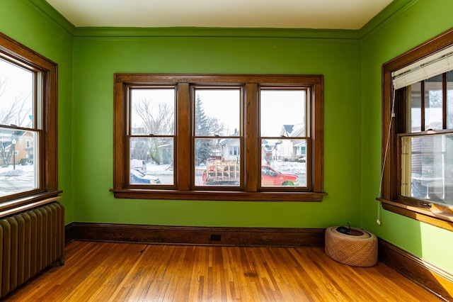 unfurnished sunroom featuring radiator