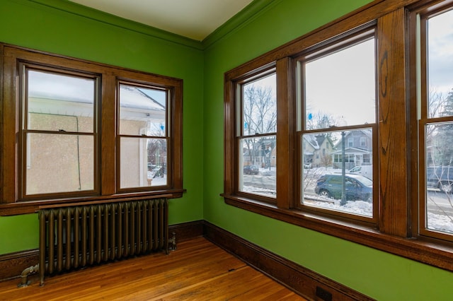 unfurnished sunroom with radiator