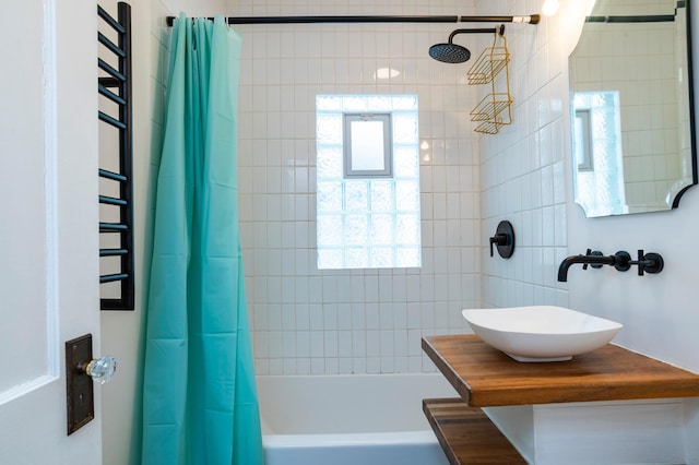 full bathroom featuring shower / bath combination with curtain and vanity