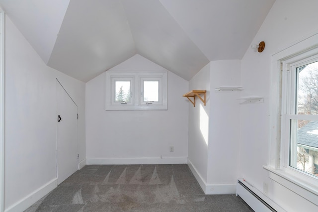 additional living space with carpet floors, baseboards, vaulted ceiling, and baseboard heating