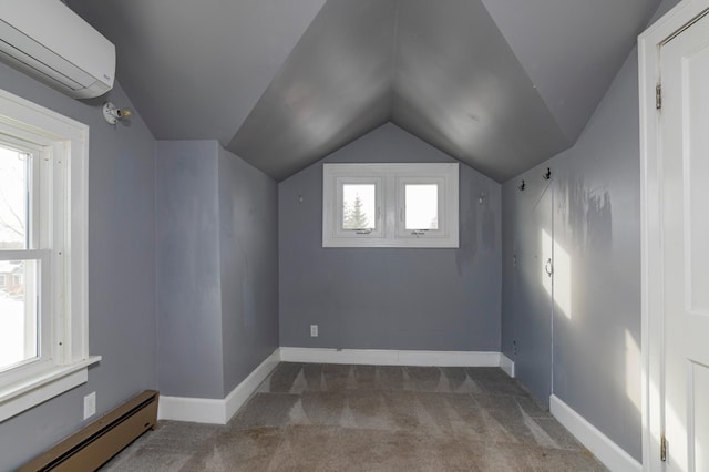 additional living space featuring carpet, a baseboard heating unit, an AC wall unit, vaulted ceiling, and baseboards