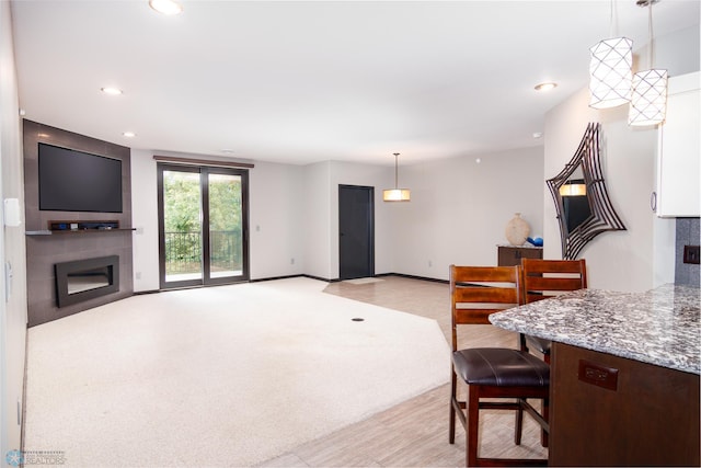 carpeted dining area featuring a large fireplace